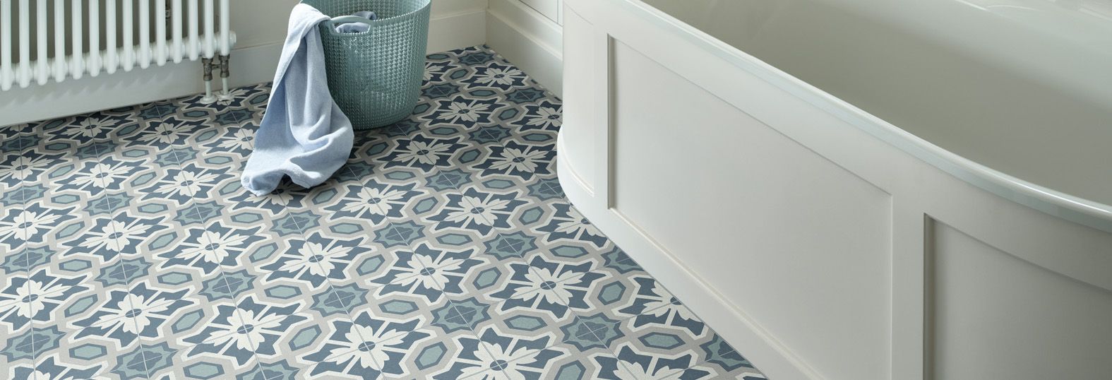 A modern white bathroom with a blue floral vinyl floor